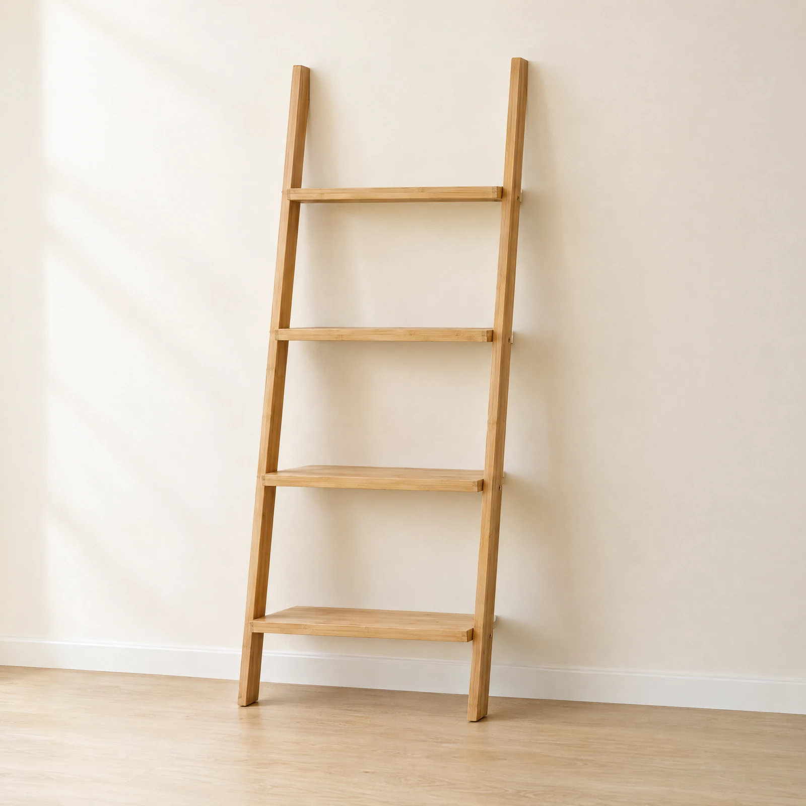Empty four-tier light natural-tone ladder shelf leaning against a cream wall
